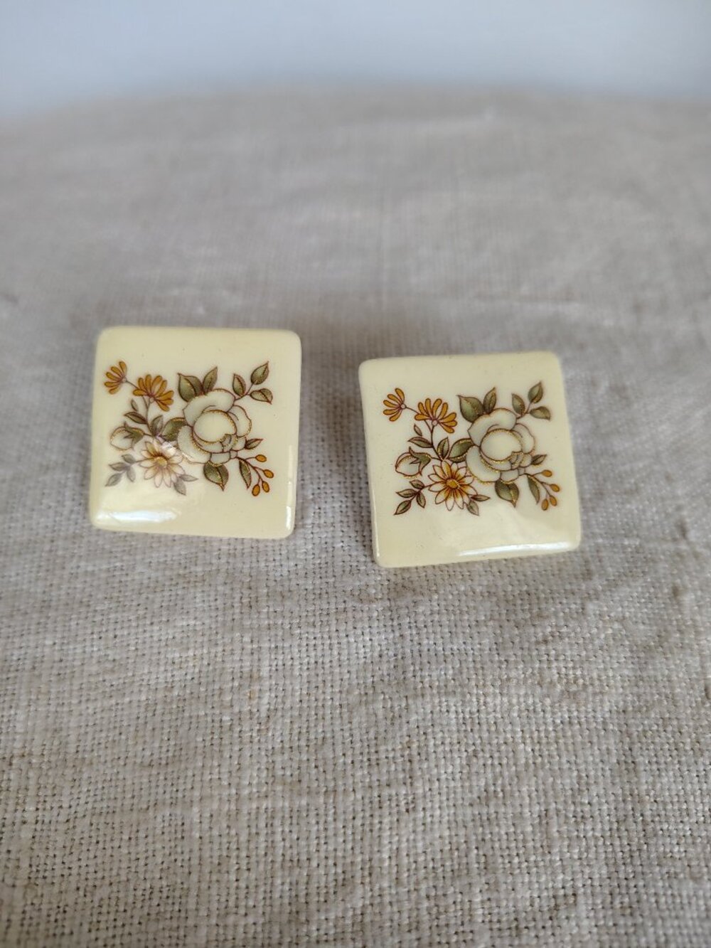 Vintage floral design push back earrings on ceramic tiles.